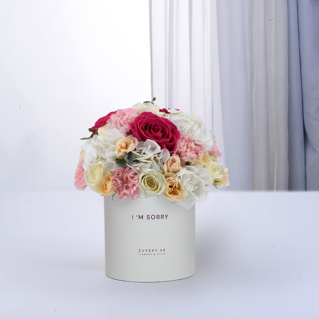 Soft pastel roses and carnations in cream box reading "I&