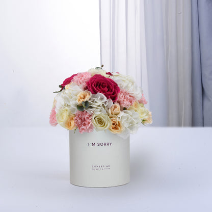 Soft pastel roses and carnations in cream box reading "I&