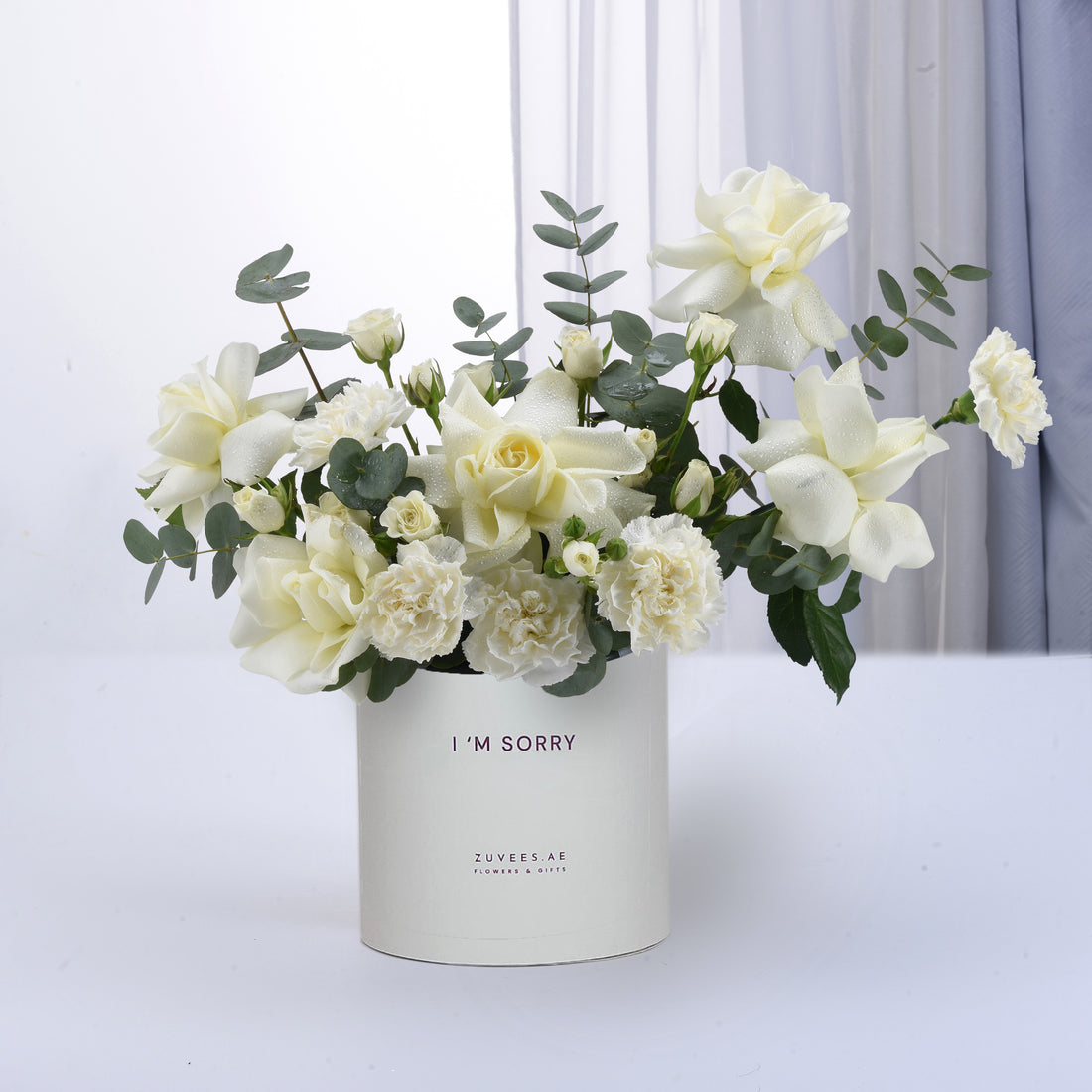 White roses and carnations in minimalist vase with “I&