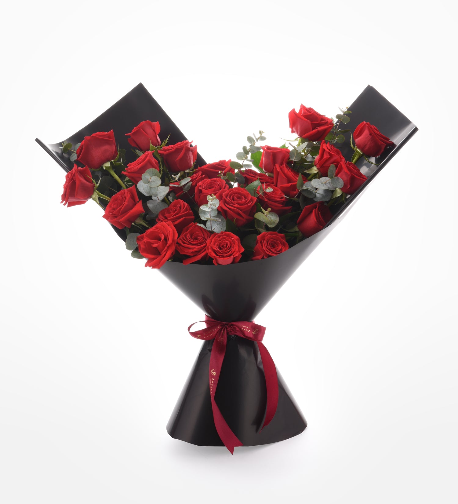 Vibrant red roses in sleek black wrap, accented with eucalyptus and red ribbon.