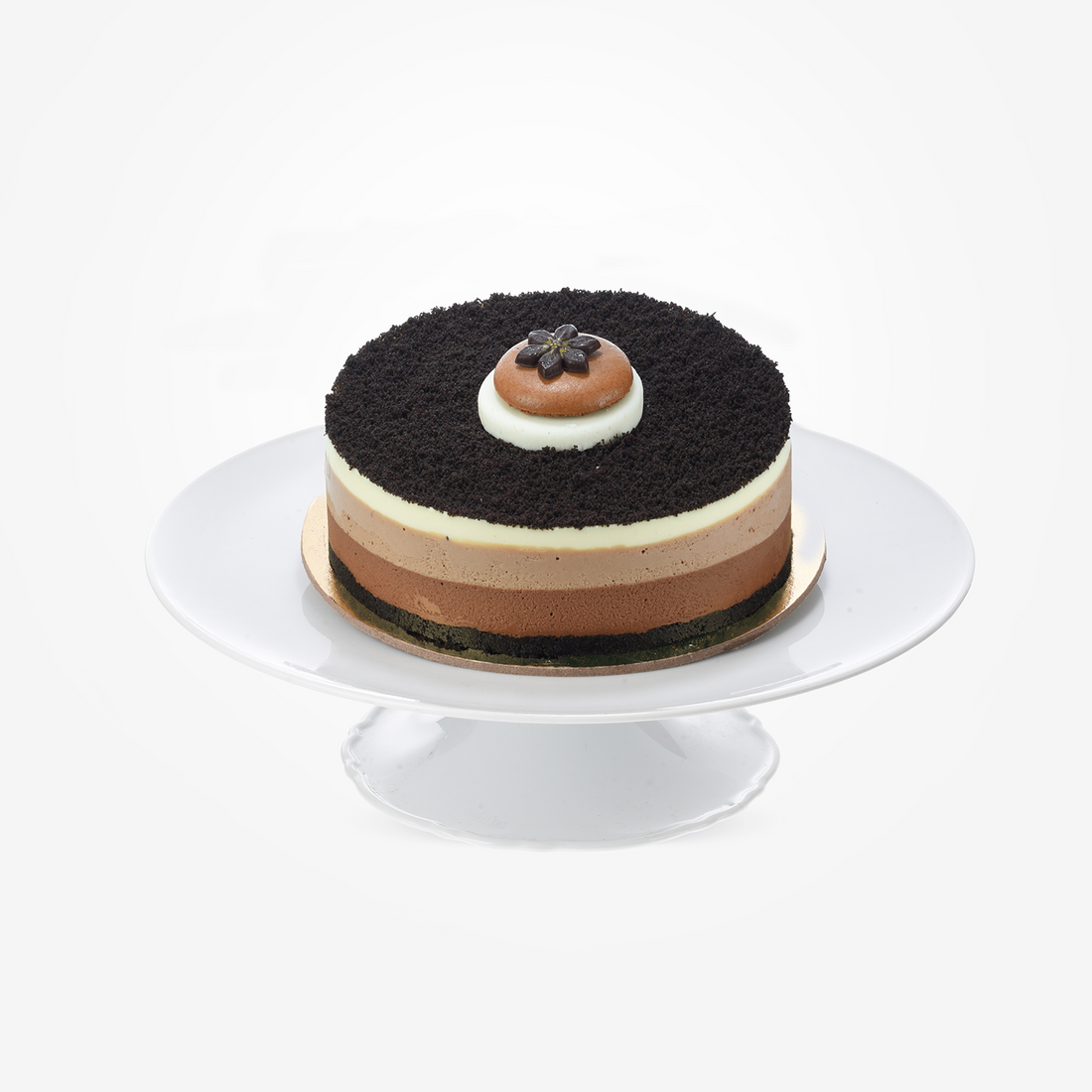 Layered chocolate cake with cookie crust, topped with delicate chocolate flower.
