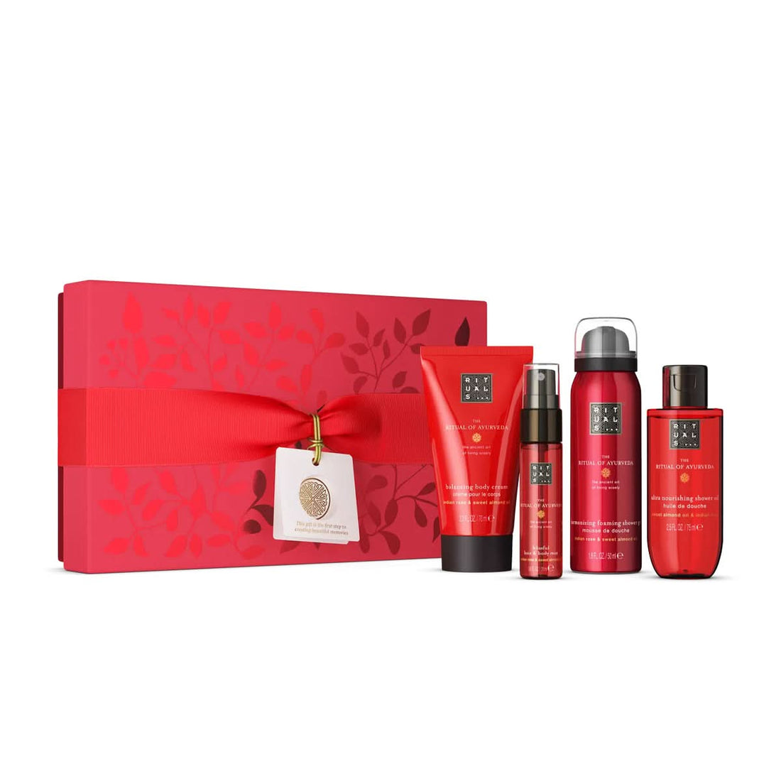 Vibrant red gift set with leaf patterns, featuring four matching Ayurveda skincare products.