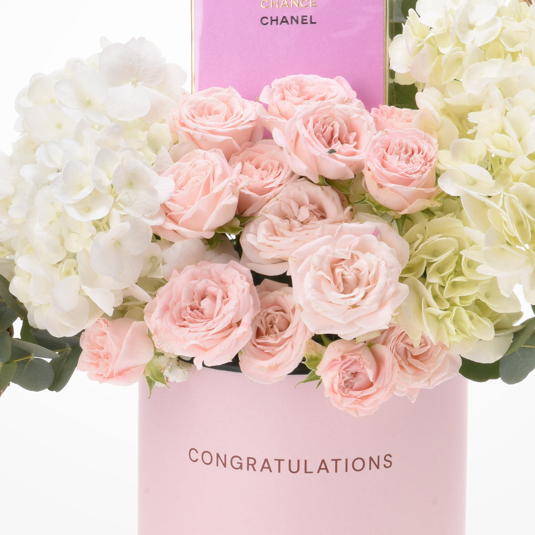Pink roses and hydrangeas in branded pink "Congratulations" vase.