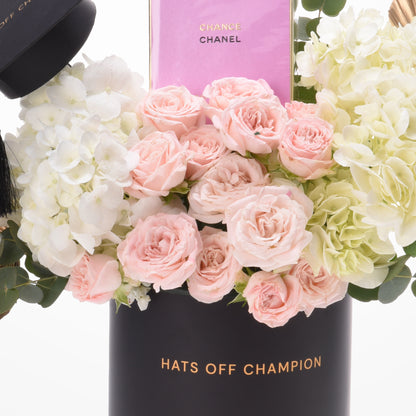 Pink roses and hydrangeas in black "Hats Off Champion" vase with Chanel Chance perfume.