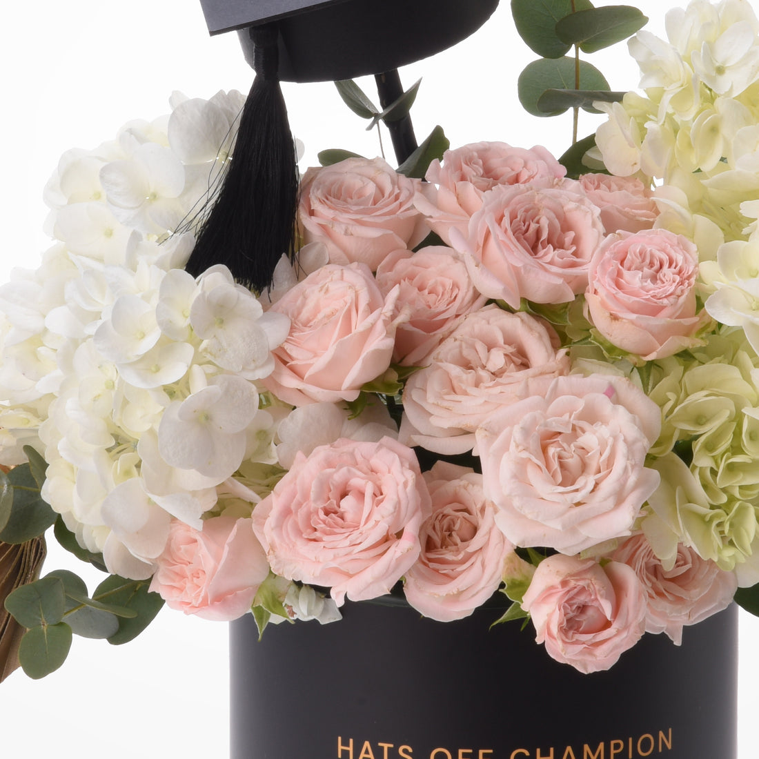Pink roses and white hydrangeas crowned with graduation cap.