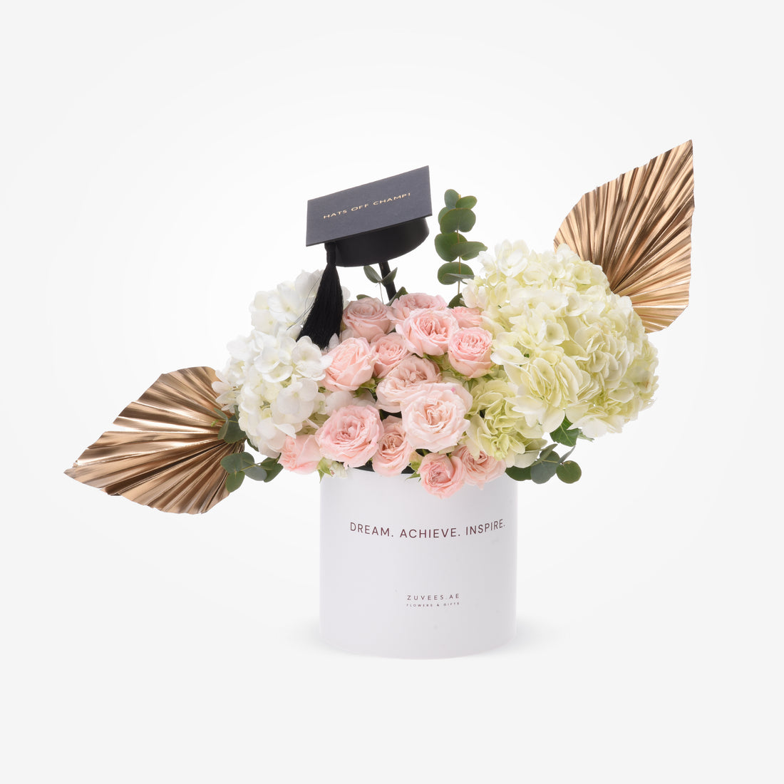 Elegant graduation bouquet with pink roses, white hydrangeas, gold leaves, and a black cap.