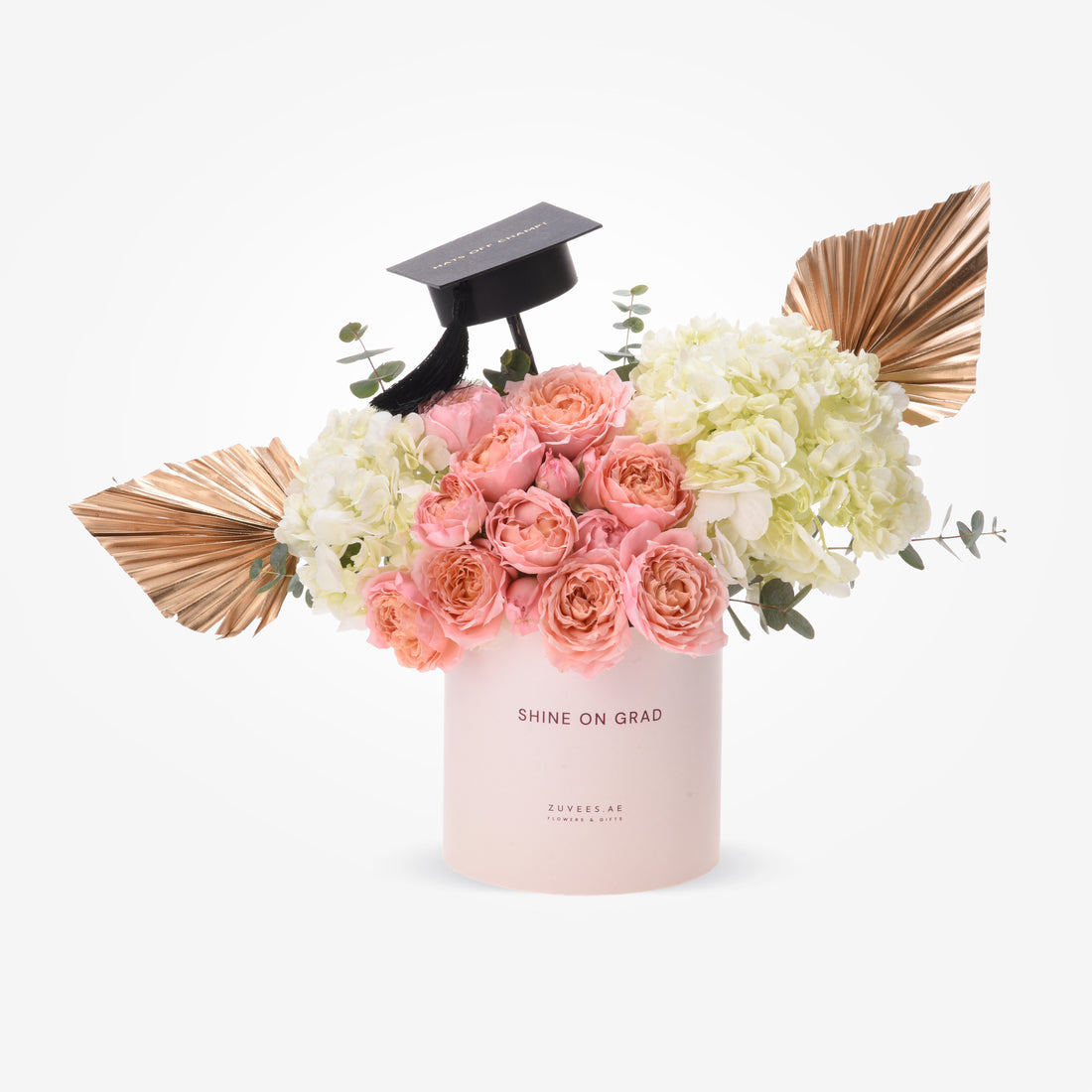 Pink roses and hydrangeas in blush box, topped with graduation cap and gold fans.