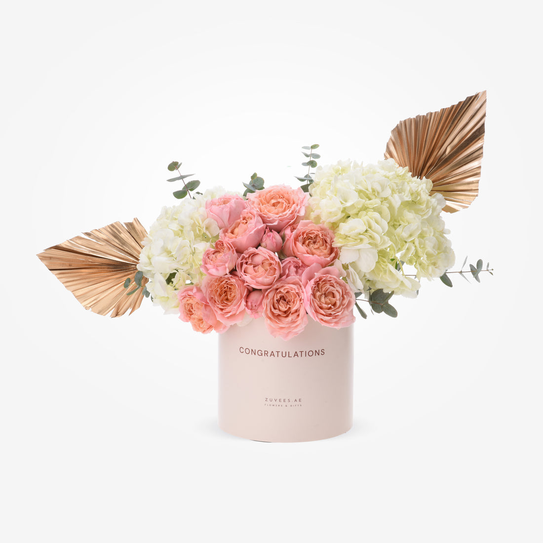 Soft pink roses and cream hydrangeas in blush box with gold leaf accents.