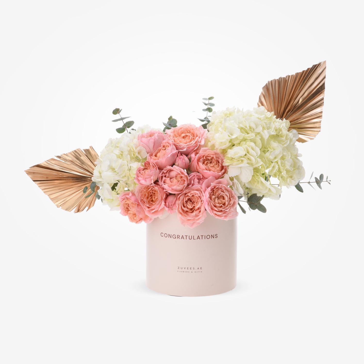 Soft pink roses and cream hydrangeas in blush box with gold leaf accents.