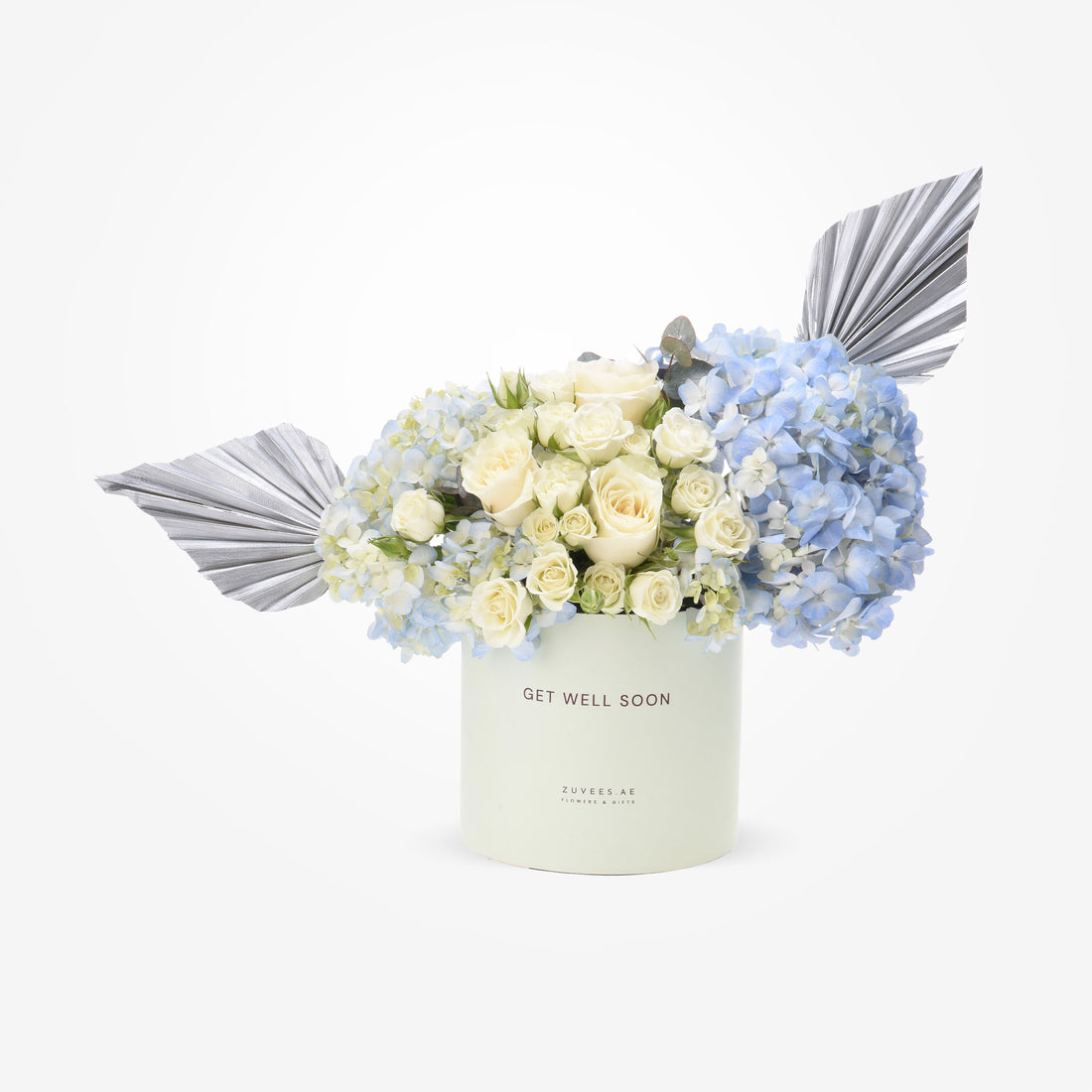 Elegant white roses, blue hydrangeas, silver foliage in mint "Get Well Soon" gift box.