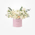 Soft pink box holds creamy white roses and eucalyptus, celebrating baby girl arrival.