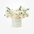 Soft white roses and eucalyptus in mint "Get Well Soon" cylinder.