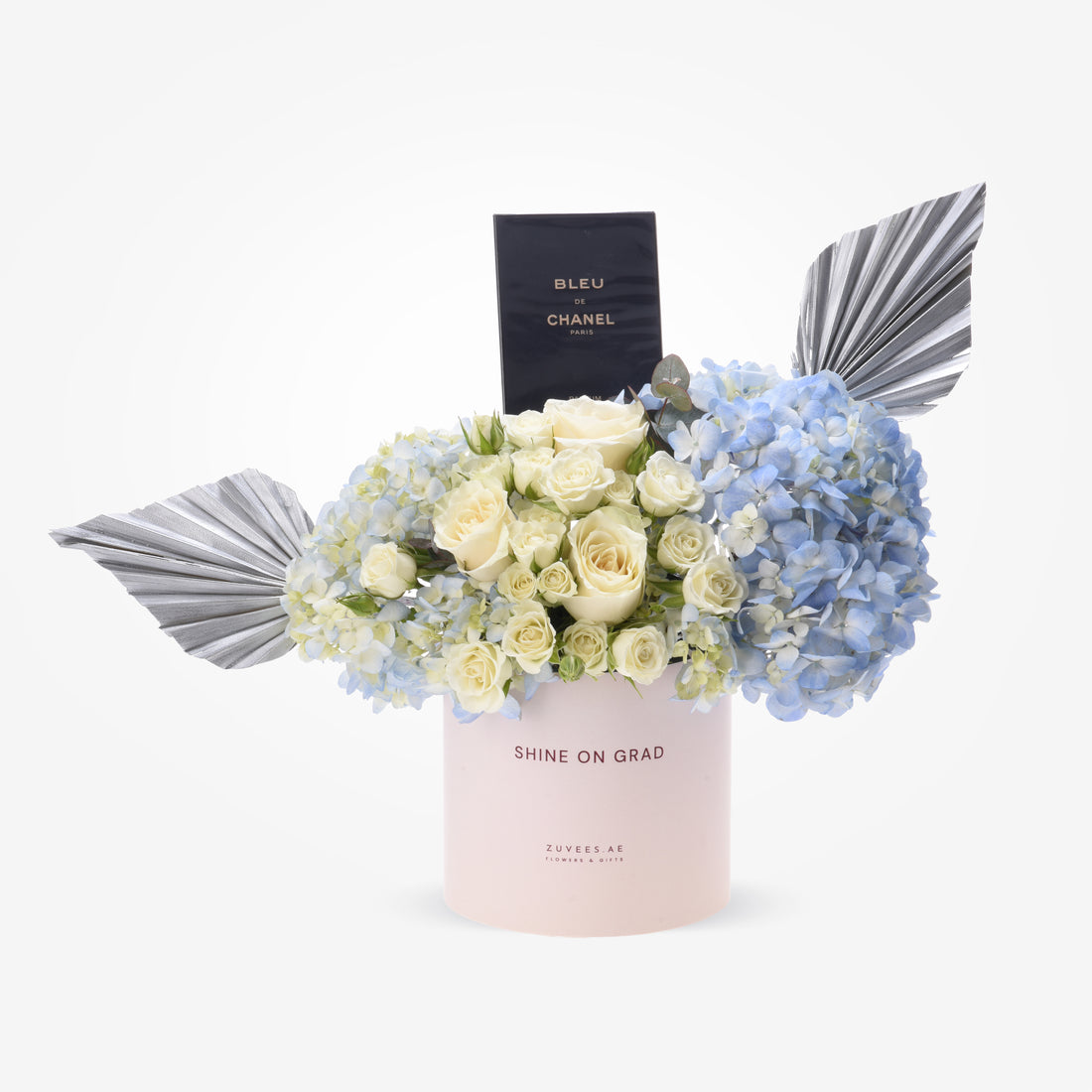 Elegant pastel pink box with white roses, blue hydrangeas, and silver fan accents.