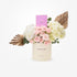 Elegant pink roses and hydrangeas in cream cylinder with gold accents and Chanel perfume.