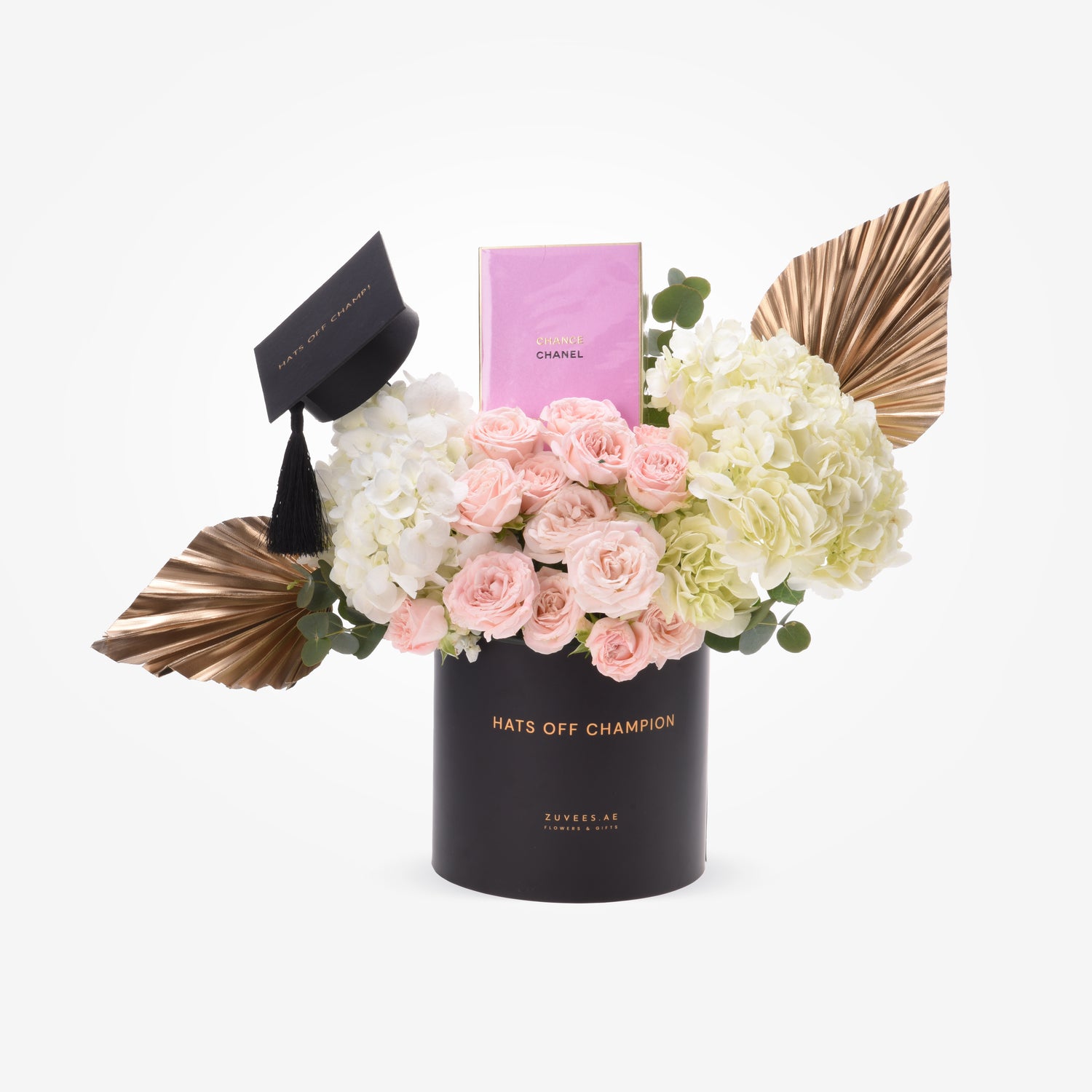 Black graduation cap, pink roses, hydrangeas, gold accents, Chanel perfume, "Hats Off Champion" gift.