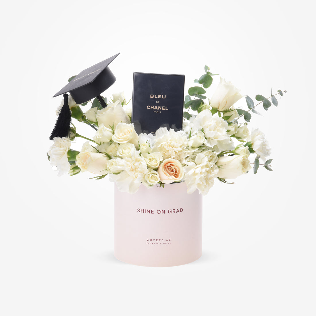 Elegant white floral graduation gift with Chanel perfume and mortarboard in blush box.