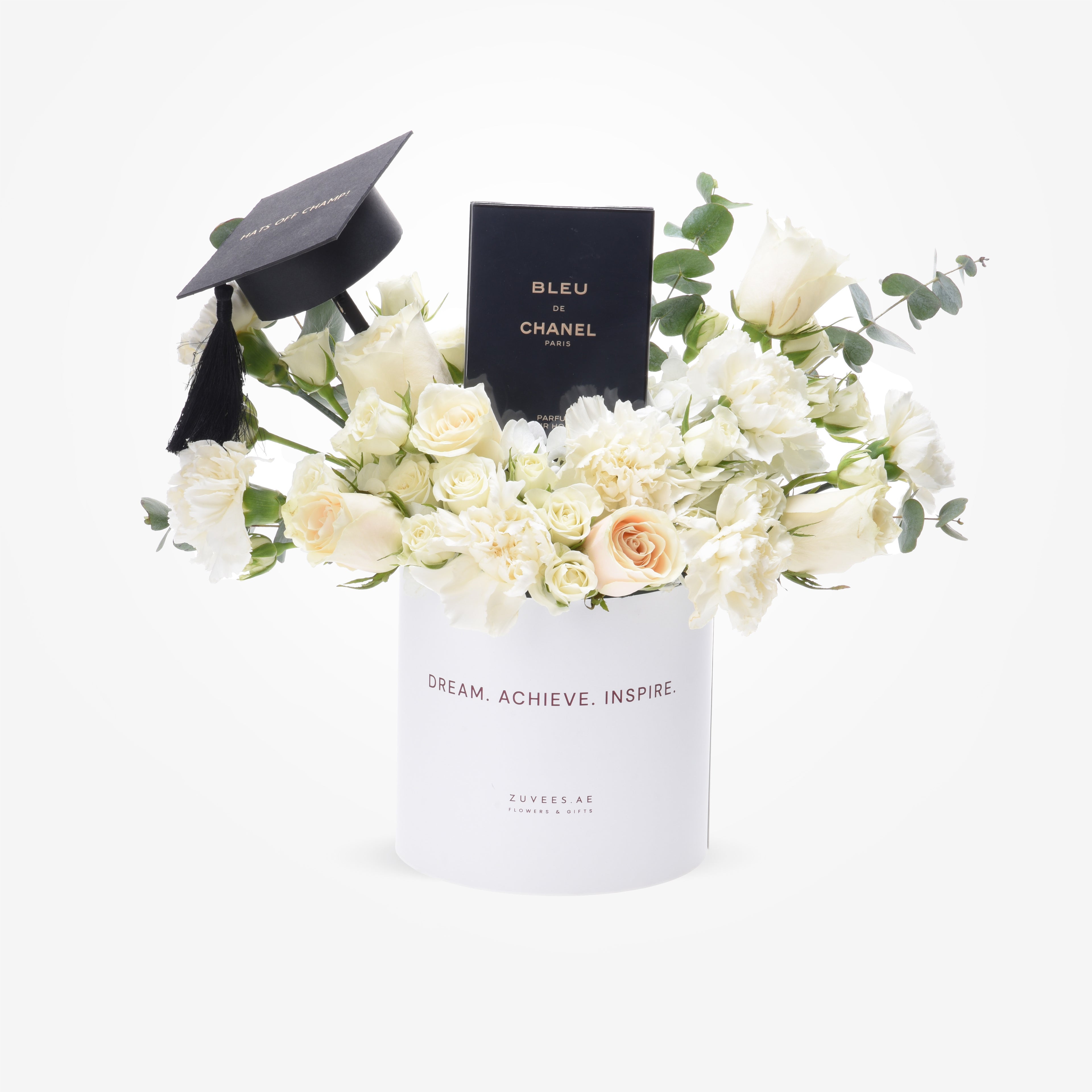 White floral graduation gift with Chanel perfume and black cap.