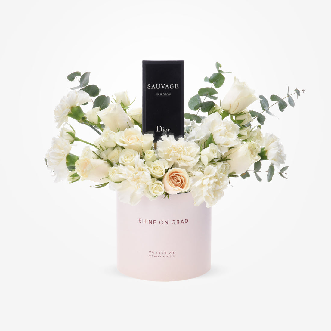 Elegant white roses and eucalyptus surround Dior Sauvage perfume in blush cylinder.