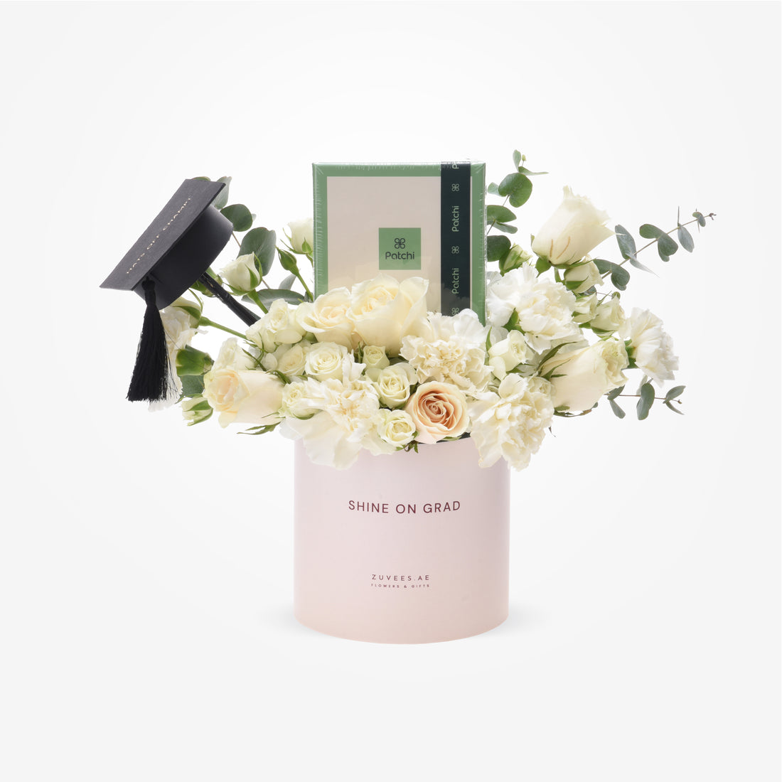 Elegant white roses and eucalyptus in blush box with graduation cap and Patchi gift.