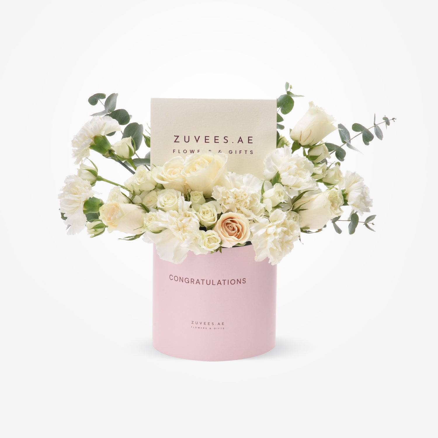Elegant white roses, carnations, eucalyptus in pink "Congratulations" box by Zuvees.AE.