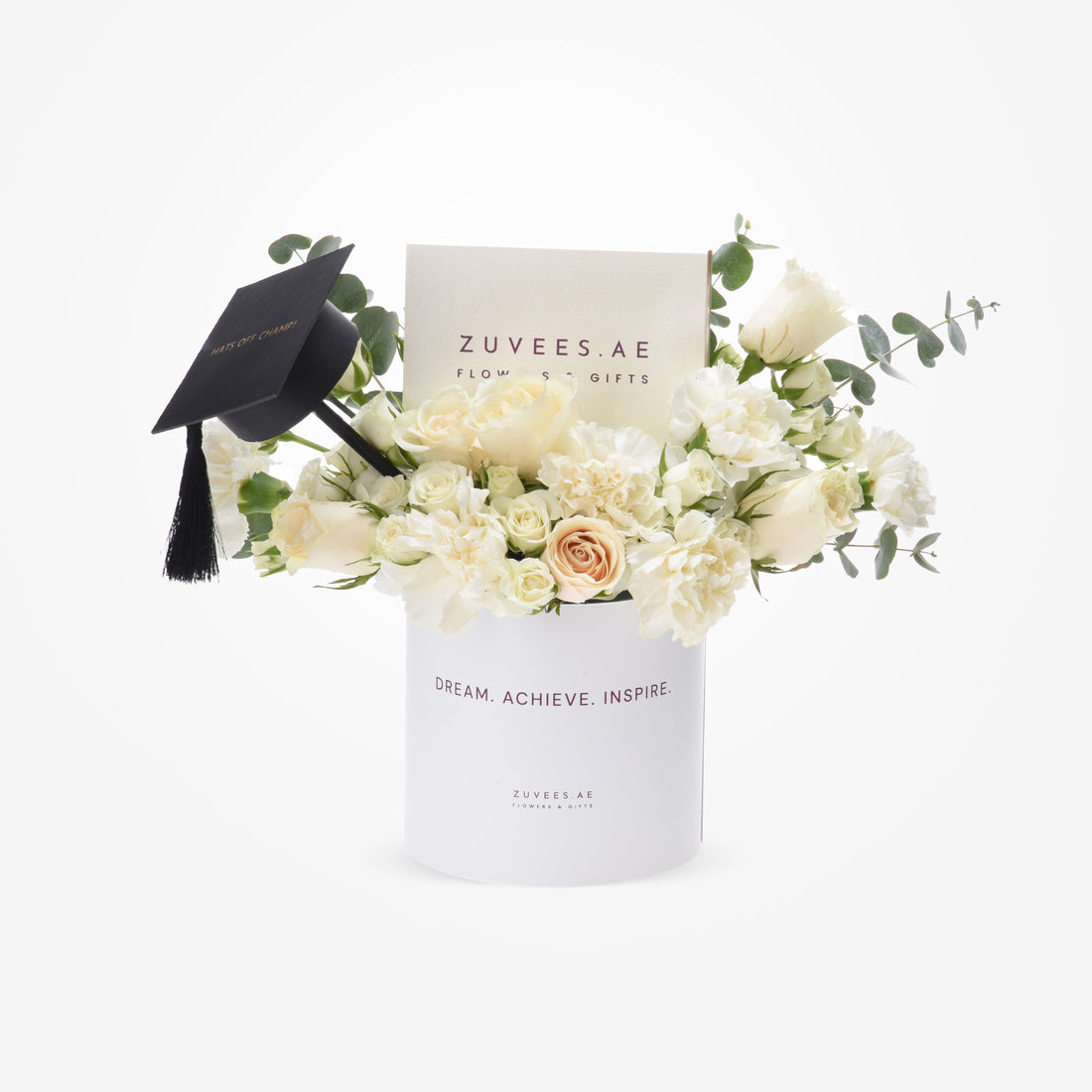 White roses, carnations, eucalyptus in white box with black graduation cap, "Hats Off Champ!" inscription.