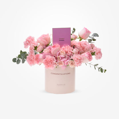Soft pink roses and carnations in blush box with "Congratulations" and Chanel perfume.