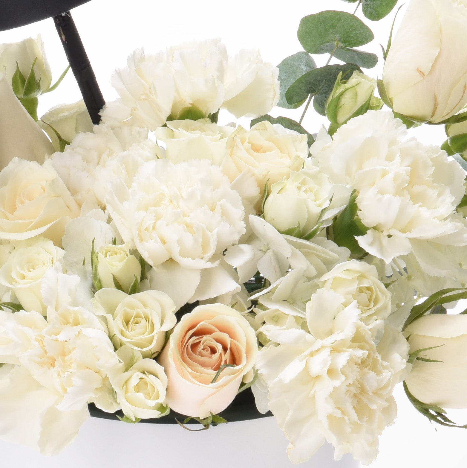Elegant white rose and carnation bouquet accented with one blush rose and eucalyptus.