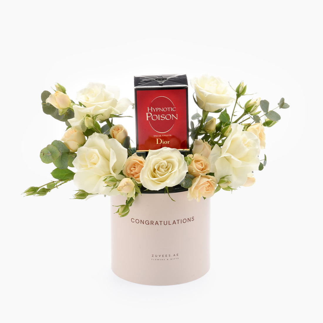 Elegant white roses and eucalyptus surround a Dior Hypnotic Poison bottle in a blush "Congratulations" cylinder.