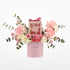 Pink floral arrangement with chocolate gift box, "It&