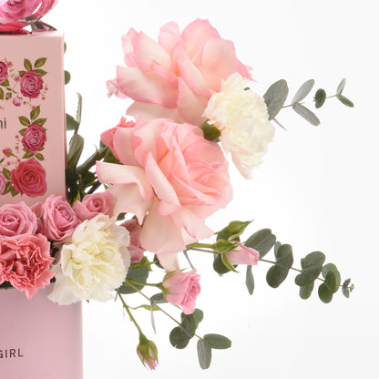 Pink roses and white carnations with eucalyptus in a floral gift box.