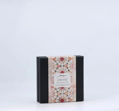 Elegant black box with intricate pink and red geometric patterned lid.