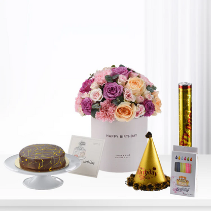 Elegant birthday bouquet, cake, party hat, and confetti popper in soft pinks, purples, and gold.