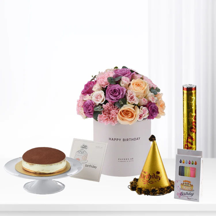 Pink, purple, peach roses in white box with cake, party hat, and confetti.