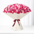Vibrant pink and purple roses in cream paper, tied with burgundy ribbon.