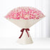 Vast dome of blush-pink roses, elegantly wrapped in cream paper with burgundy ribbon.