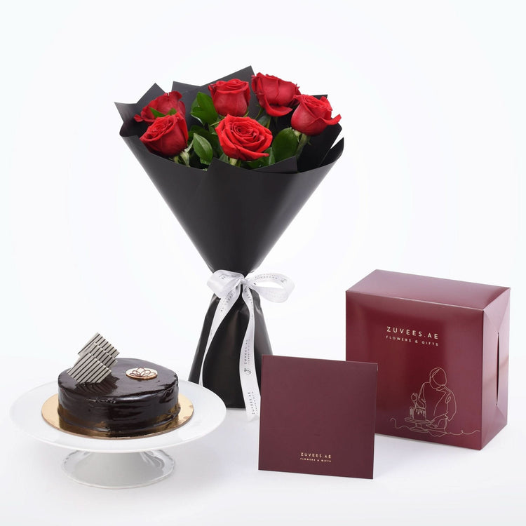 Luxurious red roses in black wrap paired with chocolate cake and branded gift boxes.