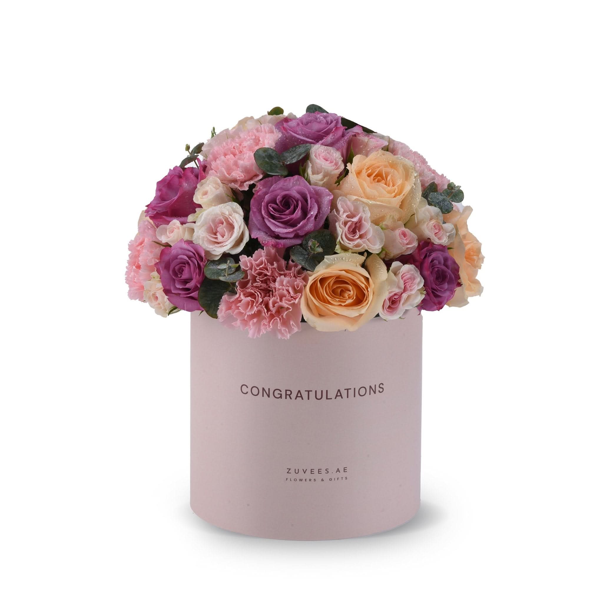 Pink box holds vibrant purple, peach, and pink roses with greenery, "Congratulations" printed.