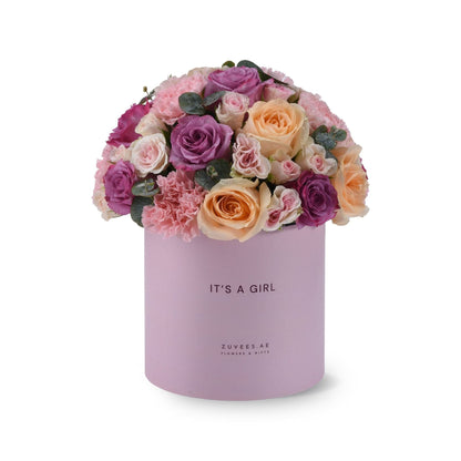 Soft pink and purple roses in lavender box reading "It&