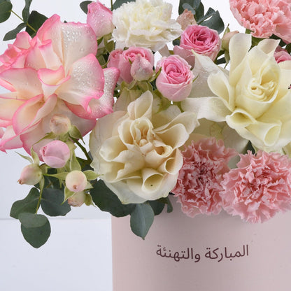 Soft pink and cream roses with dewdrops, carnations, and Arabic "Congratulations and Happy Birthday" text.