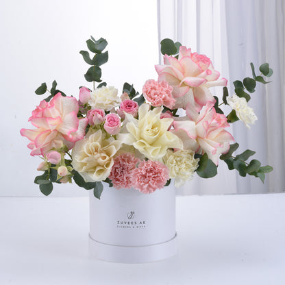 Elegant pastel roses and carnations in white box, dewdrops, eucalyptus.