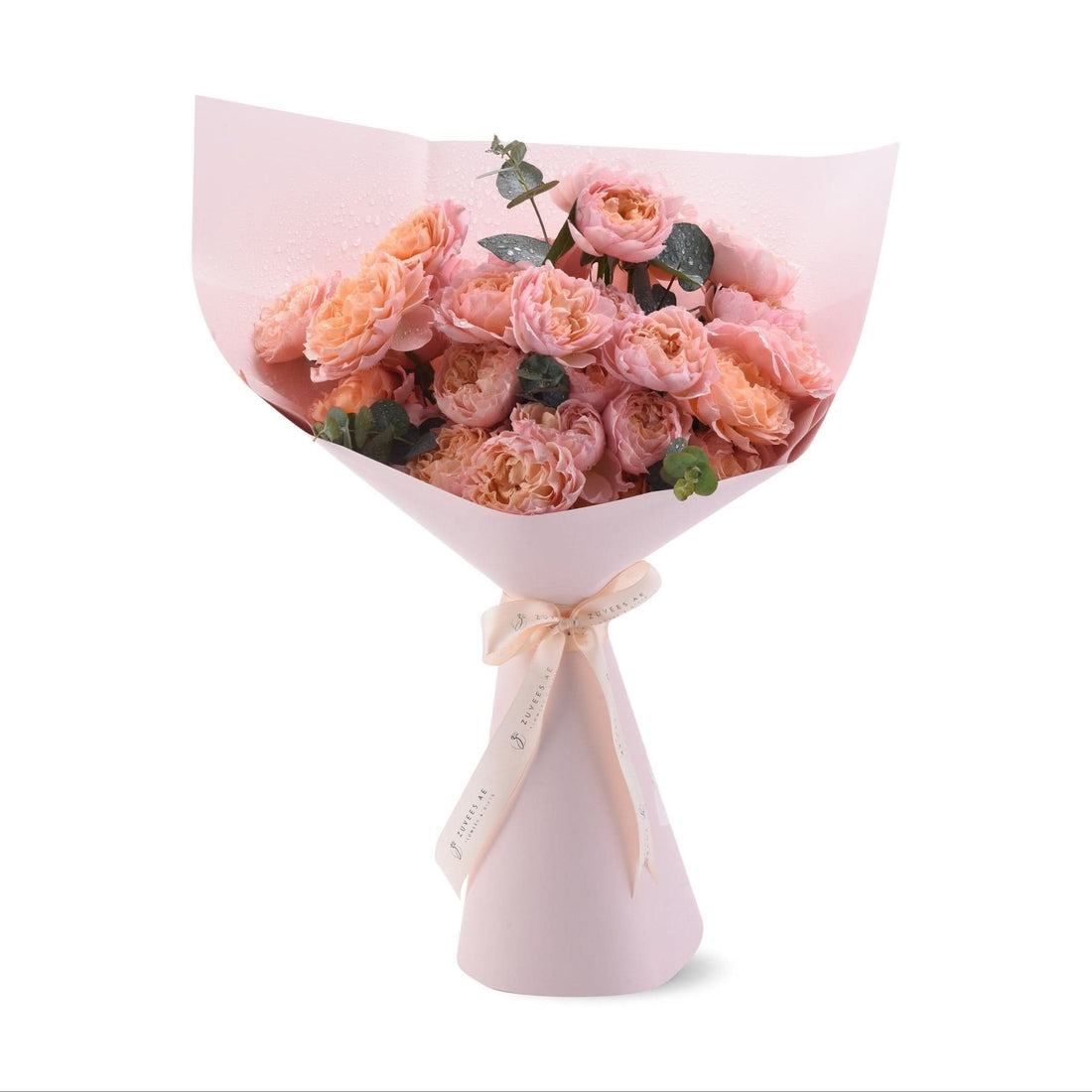 Soft pink roses with dewdrops, wrapped in matching paper and ribbon.
