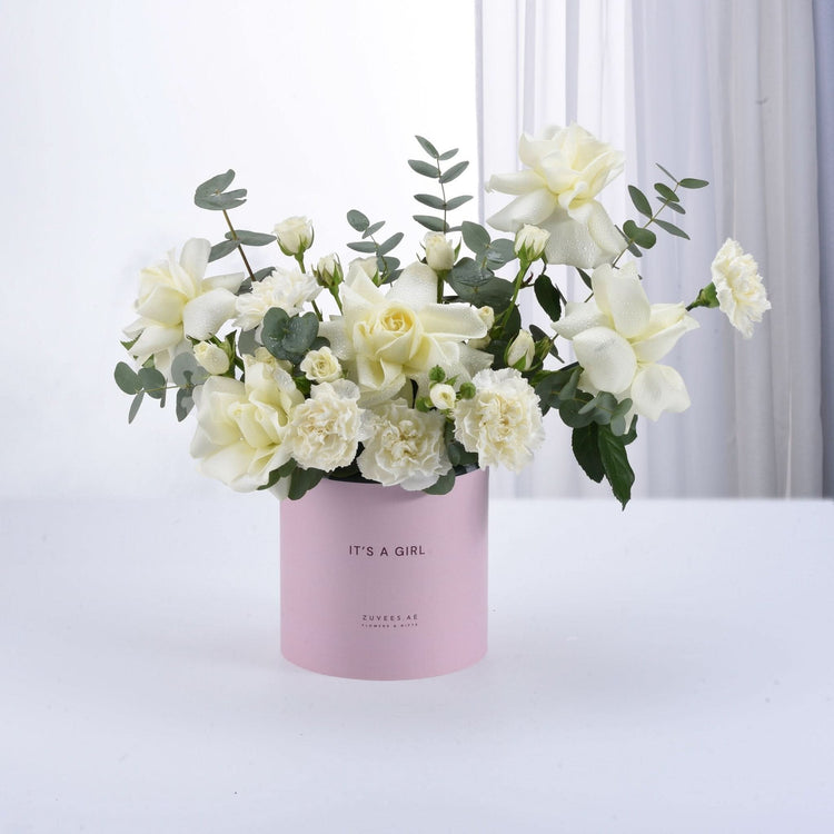 Soft white roses and eucalyptus in a pink "It&