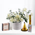 Elegant white roses in gray "Happy Birthday" vase with gold party hat and caramel gift.