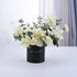 Elegant white roses and eucalyptus in matte black "Happy Anniversary" vase.
