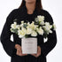 Elegant white rose and carnation bouquet in minimalist birthday box.