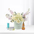 Pastel floral arrangement with honey, throat lozenges, and electrolyte for recovery.