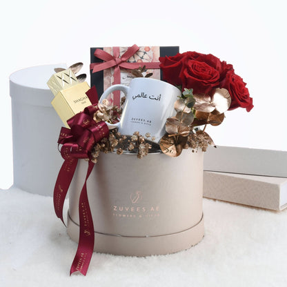 Luxury gift basket with red roses, gold accents, and personalized mug.