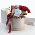 Luxury gift basket with red roses, gold accents, and personalized mug.