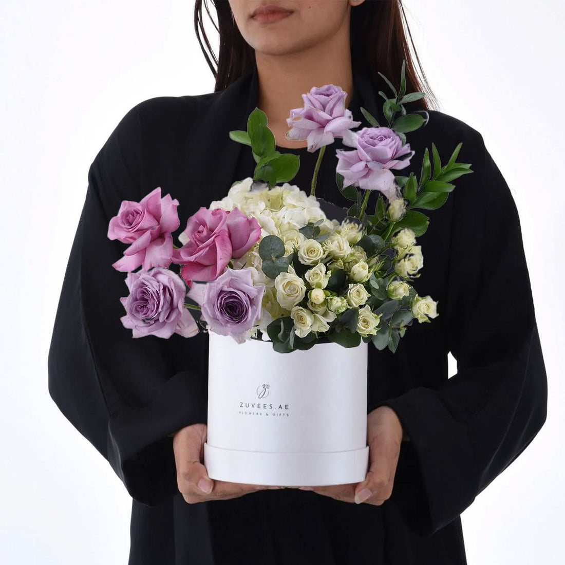 Elegant white box holds lavender, pink roses, and cream hydrangeas with lush greenery.