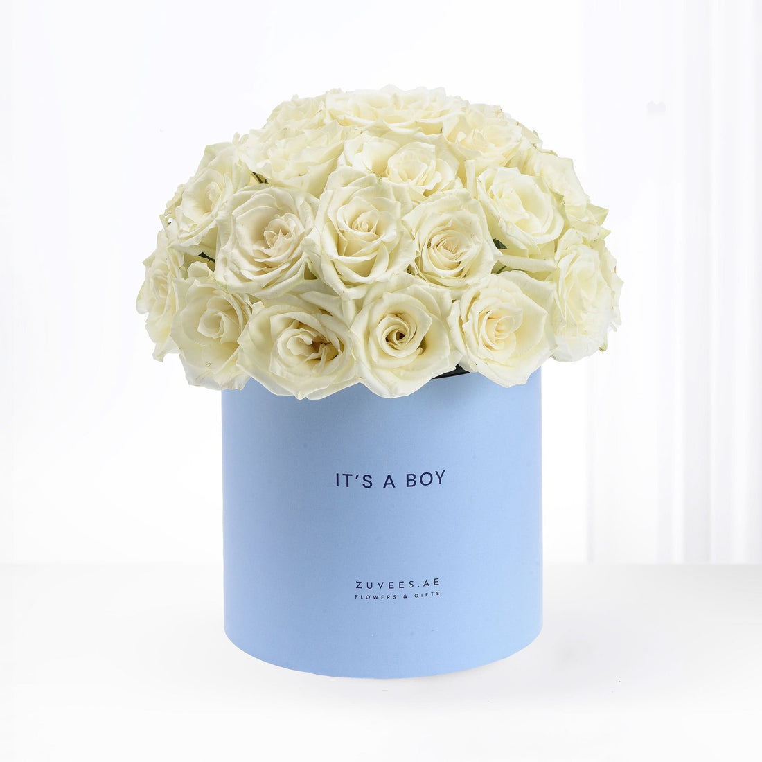 Cream roses in pastel blue box reading "It&